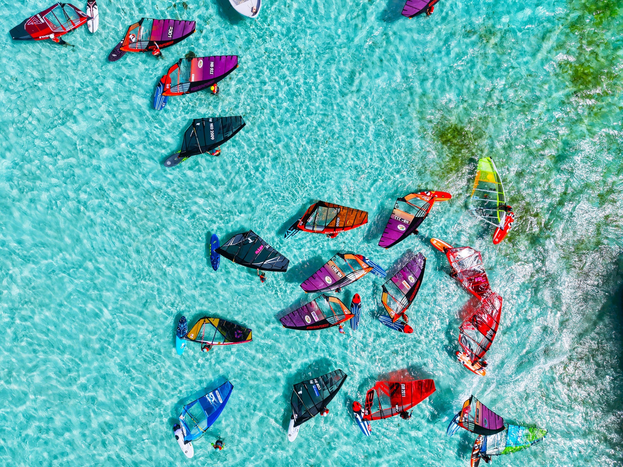 Windsurfers on clear turquoise water